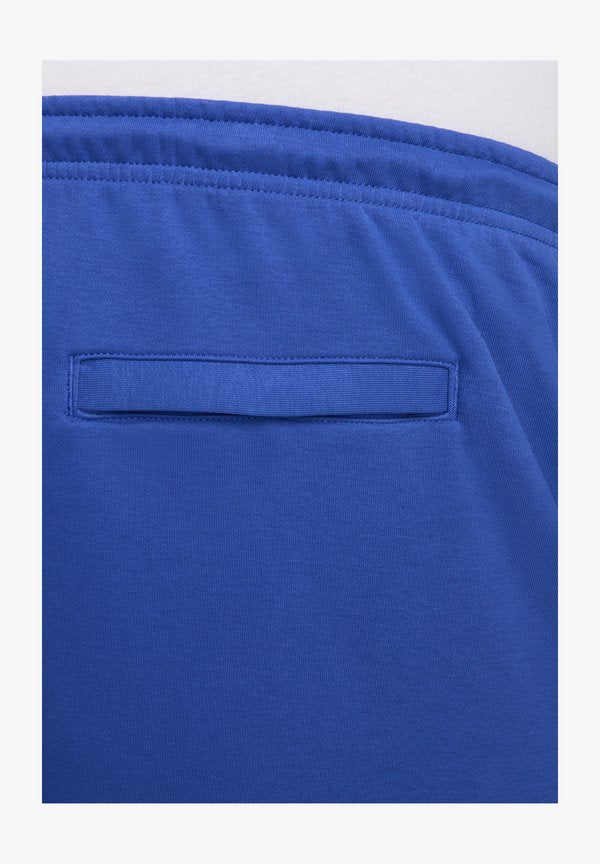 Nike Sportswear Tracksuit bottoms - game royal safety orange