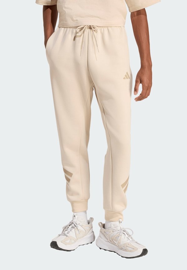 adidas Sportswear FUTURE ICONS THREE STRIPES - Tracksuit bottoms - cremeweiß