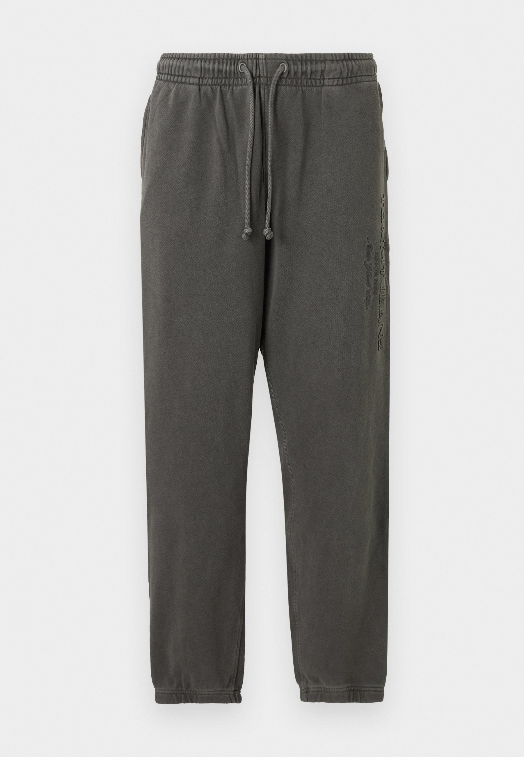 Dunkelgraue Baumwoll-Sweatpants mit elastischem Bund, Kordelzug, Seitentaschen und subtilen vertikalen Grafiken am rechten Oberschenkel.
