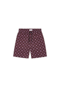 Bordeauxfarbene Badeshorts mit einem geometrischen Muster in Lavendel. Elastischer Bund mit Kordelzug und Seitentaschen. Leichtes Material.