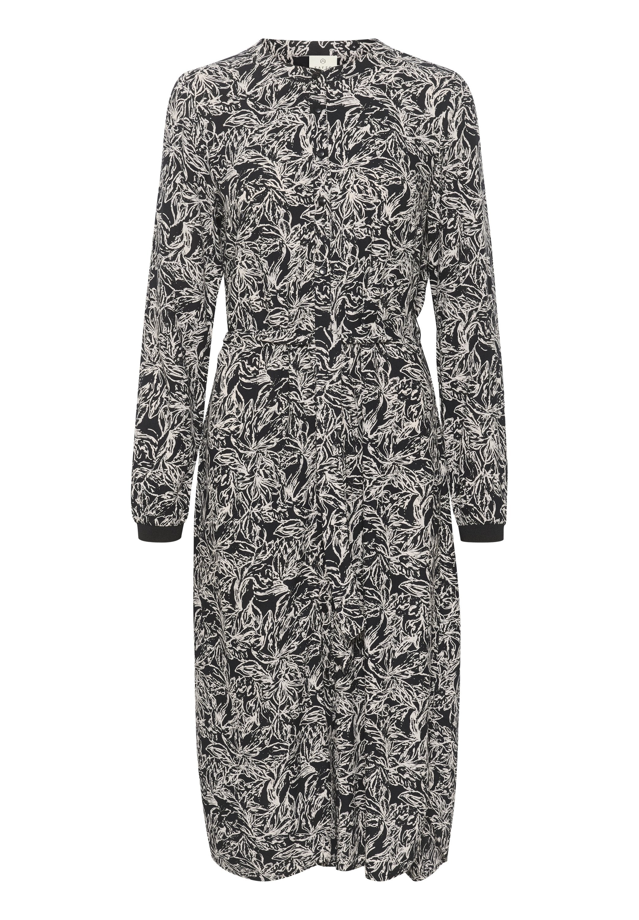 Langärmliges Kleid mit einem Schwarz-Weiß-Blattmuster. Verfügt über eine durchgehende Knopfleiste, einen elastischen Bund und geknöpfte Ärmel. Hergestellt aus leichtem Material.