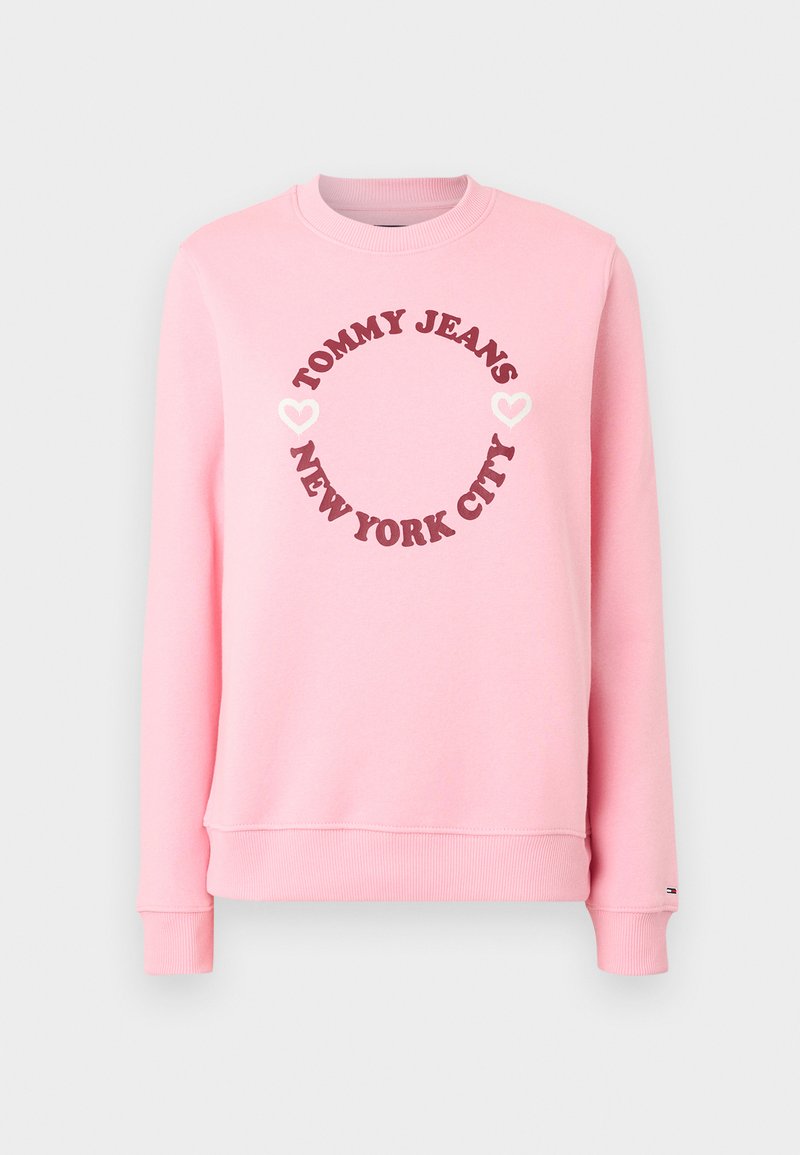 Rosa Sweatshirt aus Baumwollmischung, ausgestattet mit einem runden Logodesign mit "TOMMY JEANS" und "NEW YORK CITY" in dunklen und hellen Farben.