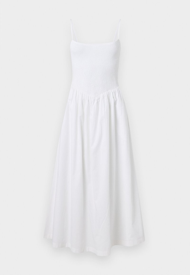 Weißes Sommerkleid mit gerafftem Oberteil, dünnen Trägern und ausgestellt Rock. Hergestellt aus leichtem Stoff, zeichnet es sich durch ein einfaches, nahtloses Design aus.