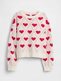Cremefarbener Pullover mit roten Herzmustern, die in Rautenmuster angeordnet sind, mit gerippten Bündchen und Saum sowie einem Rundhalsausschnitt.