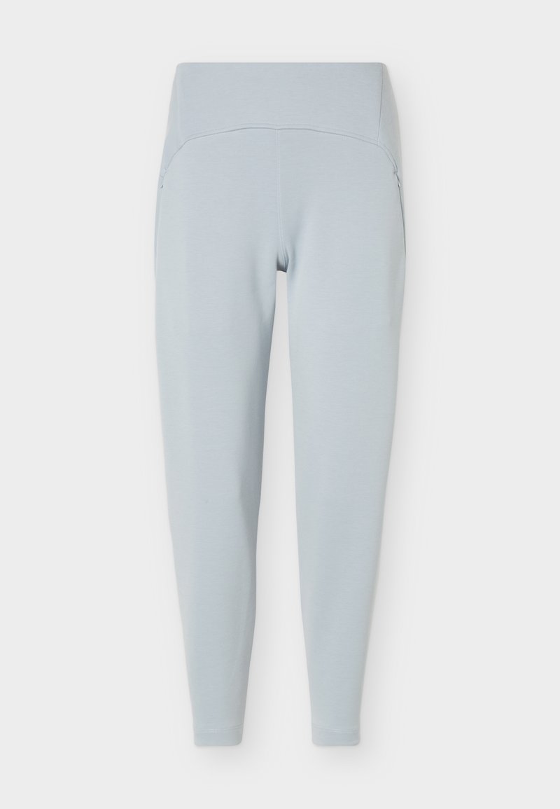 Hellblaue Leggings mit hoher Taille und schlanker Passform mit Seitentaschen, flach vor weißem Hintergrund dargestellt.