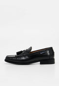 Schwarzer Leder-Tasselloafer für Herren mit niedrigem Absatz, genähtem Mokassinfuß und Markenetikett an der Seite.