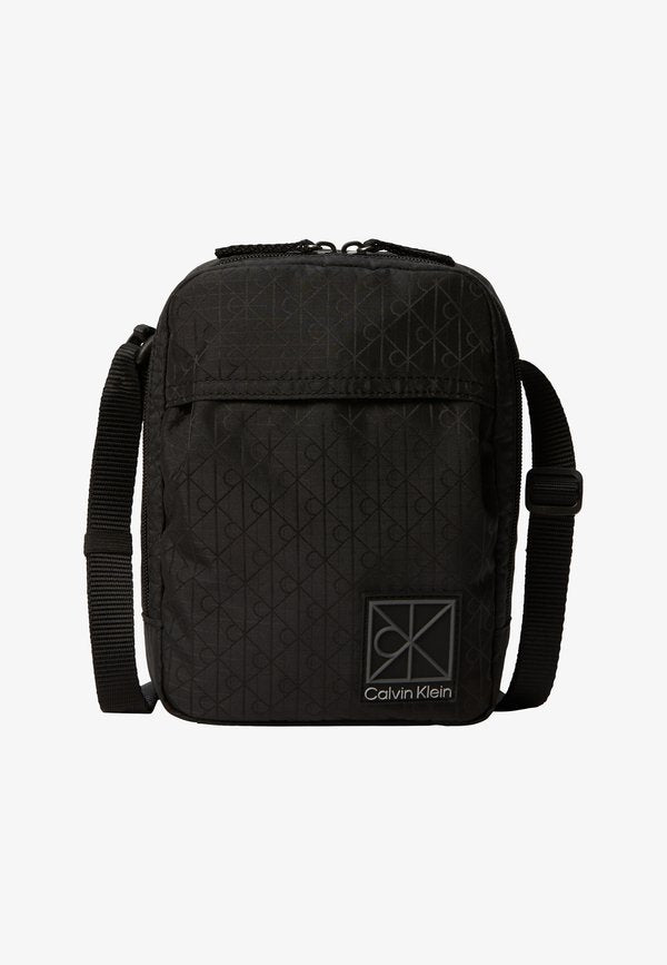Calvin Klein UTILITY EMBLEM REPORTER - Cross body bag - black