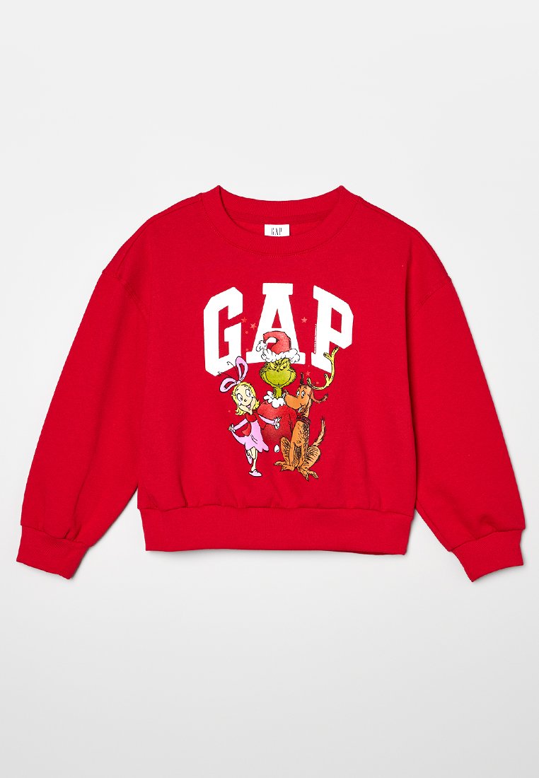 Rotes Sweatshirt mit einem auffälligen "GAP"-Logo und Comicfiguren, darunter der Grinch und ein Rentier, in leuchtenden Farben gedruckt. Weicher Stoff, lockere Passform.