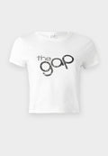 Weißes, kurz geschnittenes T-Shirt aus Baumwolle mit einem schwarzen Glitzer-Logo "the gap" auf der Vorderseite. Kurze Ärmel und runder Ausschnitt.