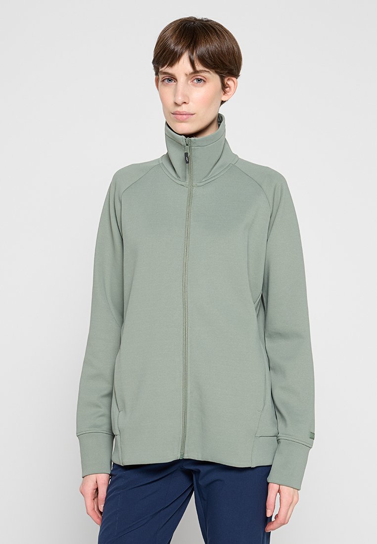 Hellgrüne Fleecejacke mit Reißverschluss, hohem Kragen, langen Ärmeln und Seitentaschen. Weiche Textur, figurbetontes Design und flache Nähte.
