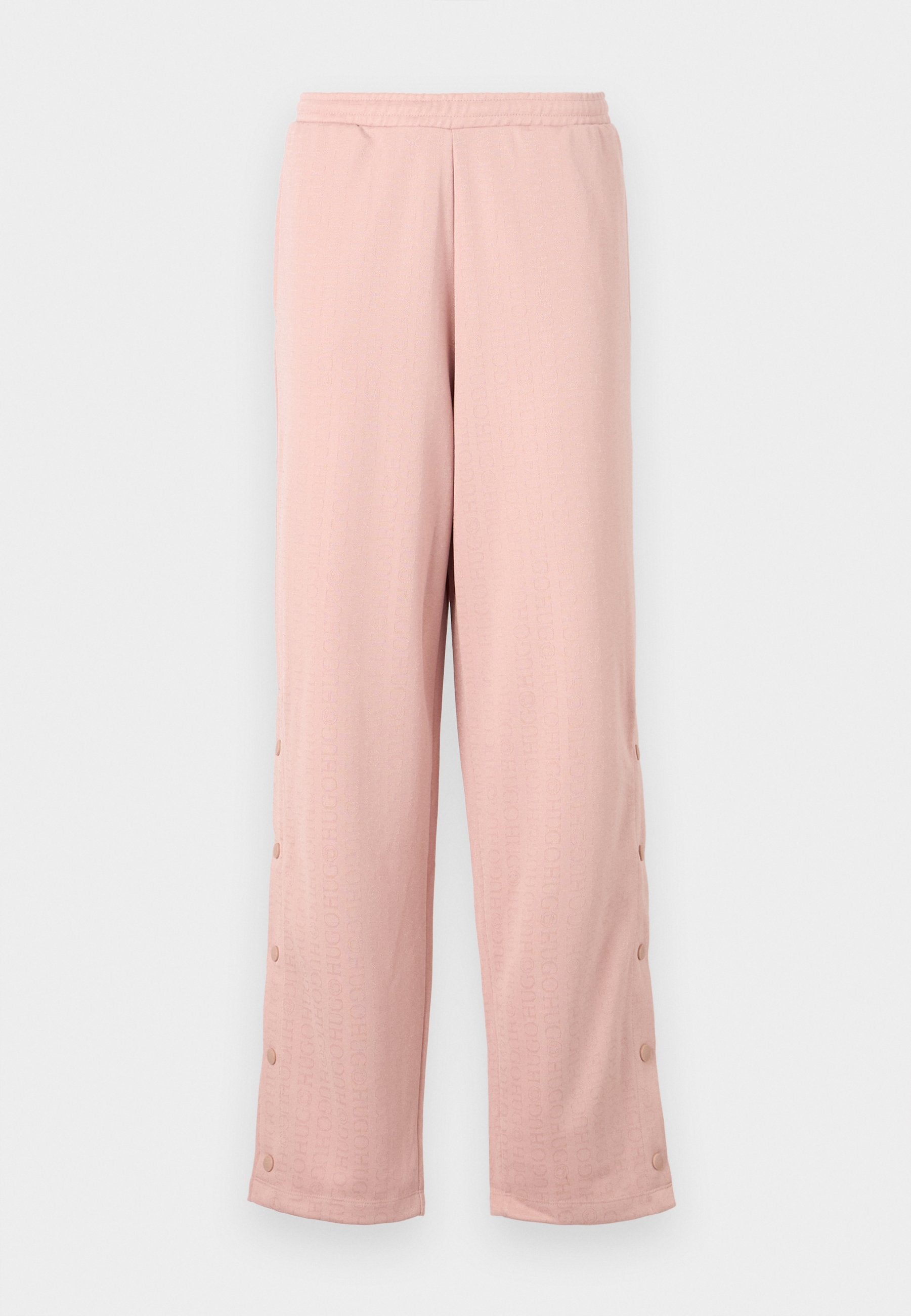 Helle rosa, weit geschnittene Hose aus weichem Stoff, mit einem dezenten geprägten Muster und dekorativen Knöpfen entlang der Seitennaht.