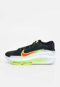 Schwarz-weißer Nike-Sneaker mit neongrünem und orangefarbenem Swoosh, grünen Schnürsenkeln und durchscheinender grüner Luftpolster-Sohle.