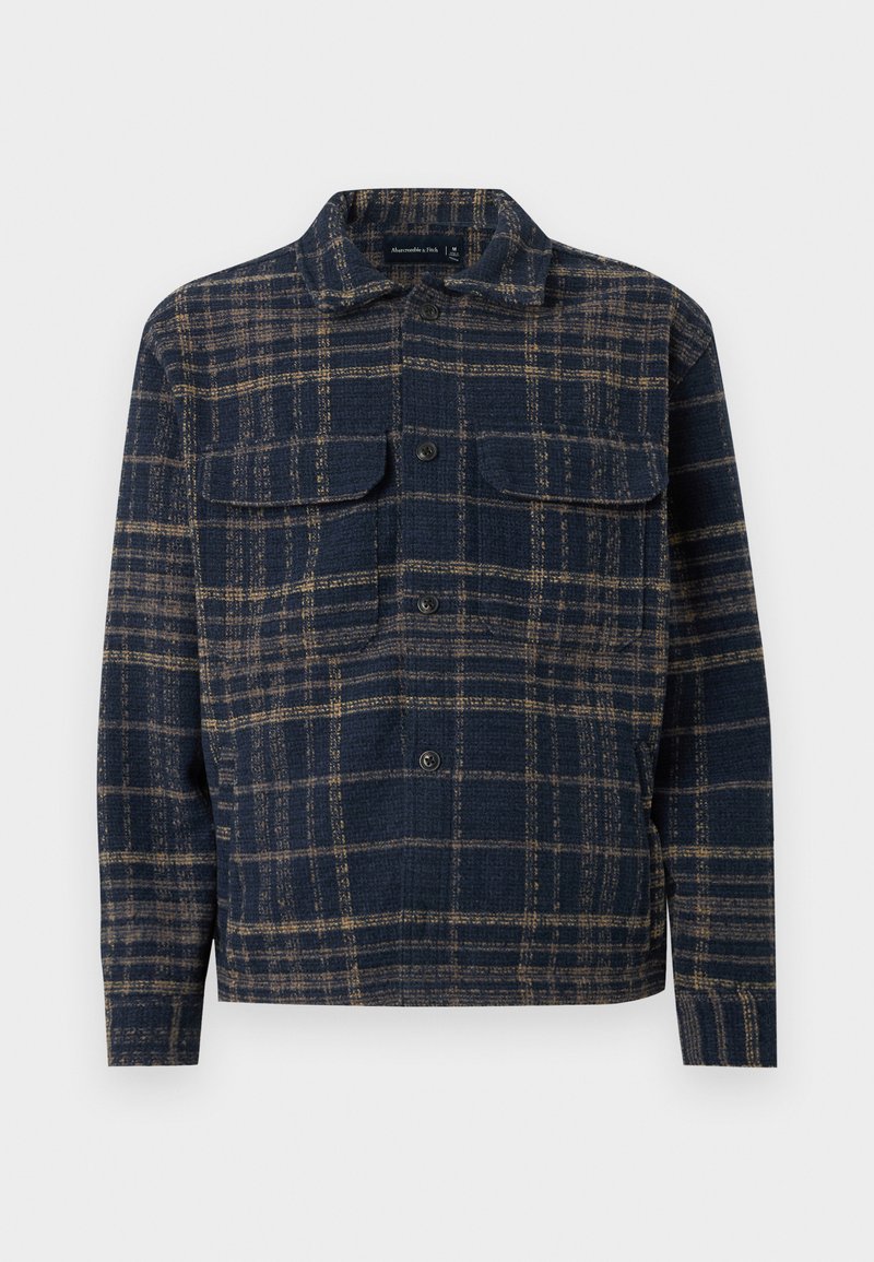 Marineblaue und braune karierte Hemdjacke mit Knopfleiste, zwei Brustklappentaschen, klassischem Kragen, langen Ärmeln und geradem Saum.