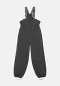 Dunkelgraue Latzhose mit verstellbaren gestreiften Trägern, elastischem Bund und elastischen Bündchen an den Knöcheln, die mit Metallschmuck verziert sind.