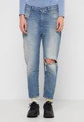 Helle blaue Denim-Jeans mit einem vernieteten Finish, featuring gerissene Knie, gerader Schnitt und klassischem Fünf-Taschen-Design. Kombiniert mit schwarzen Sneakers.