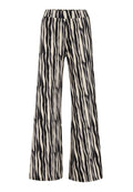 Weite Hosen mit einem schwarz-weißen Tigerstreifenmuster, aus einem strukturierten Stoff mit einem elastischen Bund.