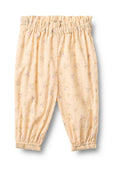 Hellgelbe Blumenhose mit einem elastischen Bund, gerafften Bündchen und einem strukturierten Stoff mit kleinen erhabenen Punkten und pastellfarbenen Blumenmustern.