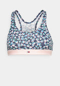 Sport-BH mit floralem Muster auf navy-blauem Grund, der pinke und grüne Akzente hat, breite Träger und ein elastisches Band mit Logo am Saum.