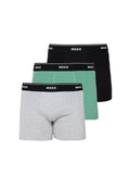Drei Paare Herren-Boxershorts in Grau, Grün mit strukturiertem Muster und einfarbig Schwarz, jeweils mit einem schwarzen Bund, der mit "MEXX" beschriftet ist.