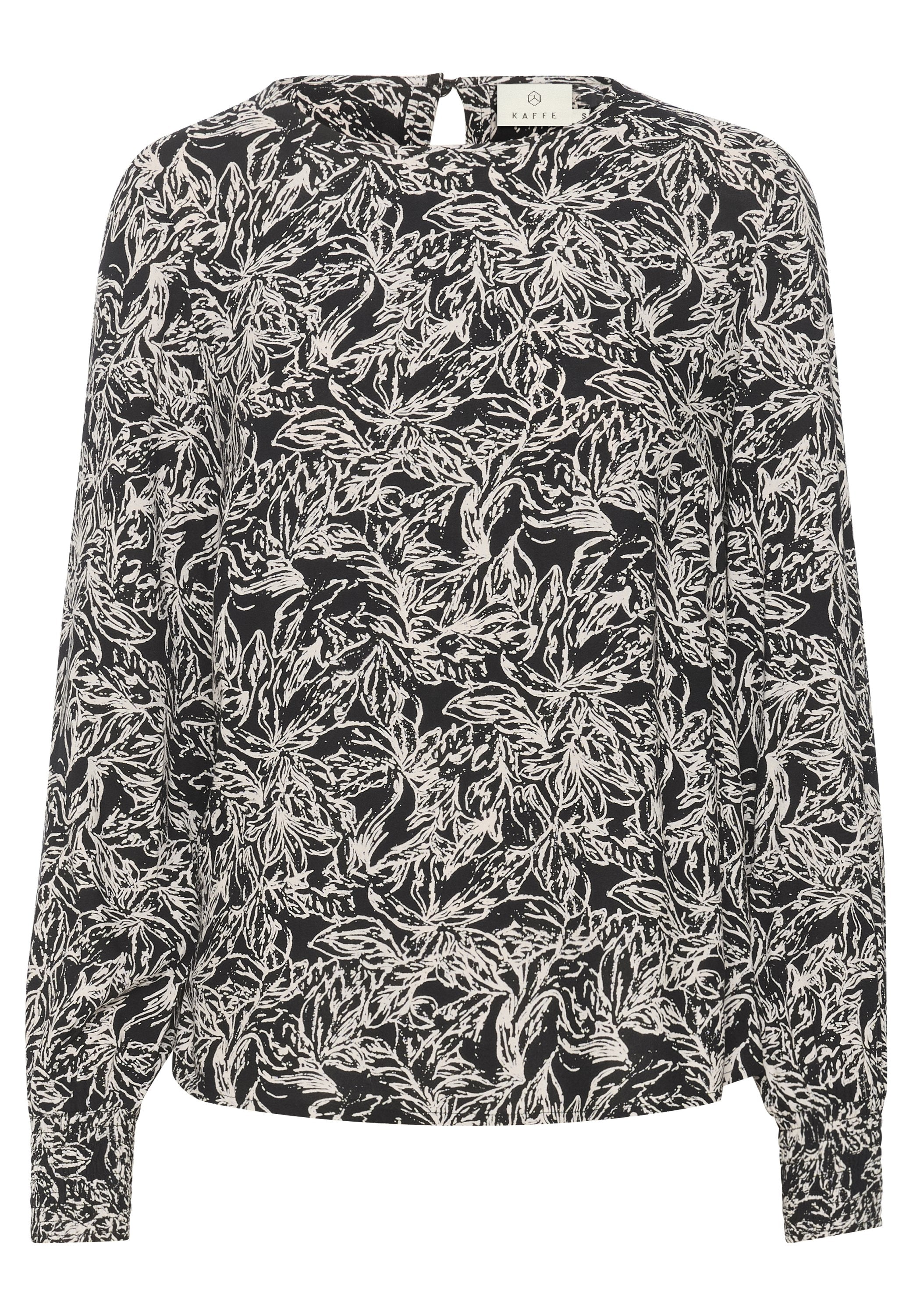 Langärmlige Bluse im schwarz-weißen Blumenmuster. Aus leichtem Stoff gefertigt, mit einem Schlitzdetail hinten und elastischen Bündchen.