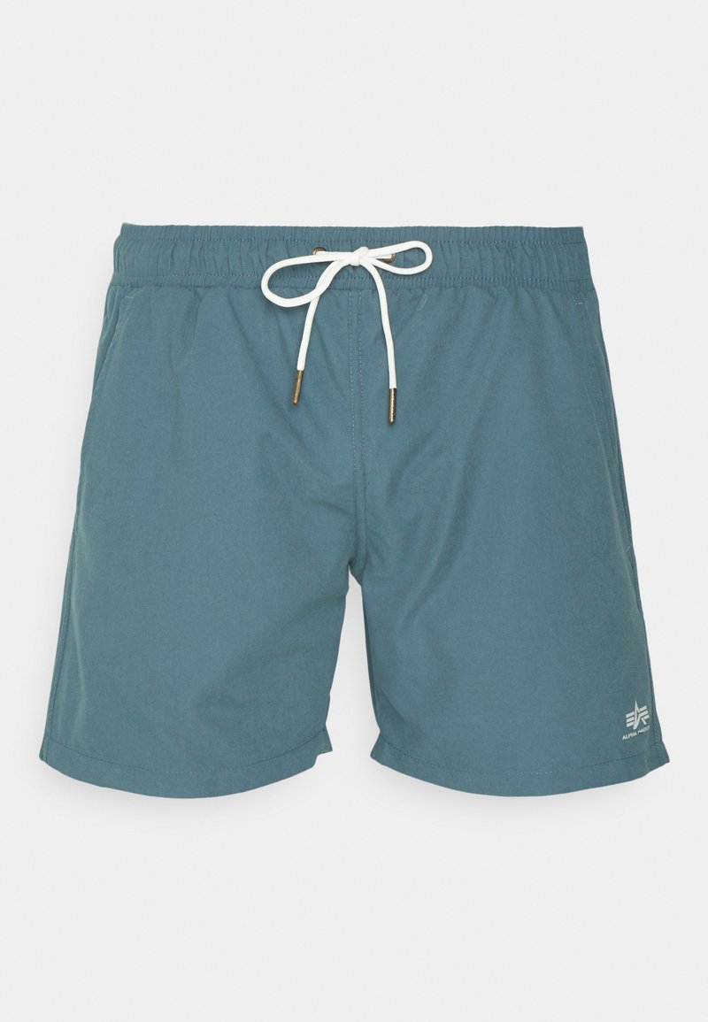 Türkisfarbene Badeshorts mit elastischem Bund und weißem Kordelzug. Verfügen über ein kleines Logo auf der unteren rechten Seite und eine glatte Textur.
