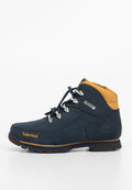 Dunkelblaues Leder-Schnürboot mit gelben Akzenten, silbernen Ösen, schwarzer Gummisohle und genähten Details. Timberland-Logo an der Seite.