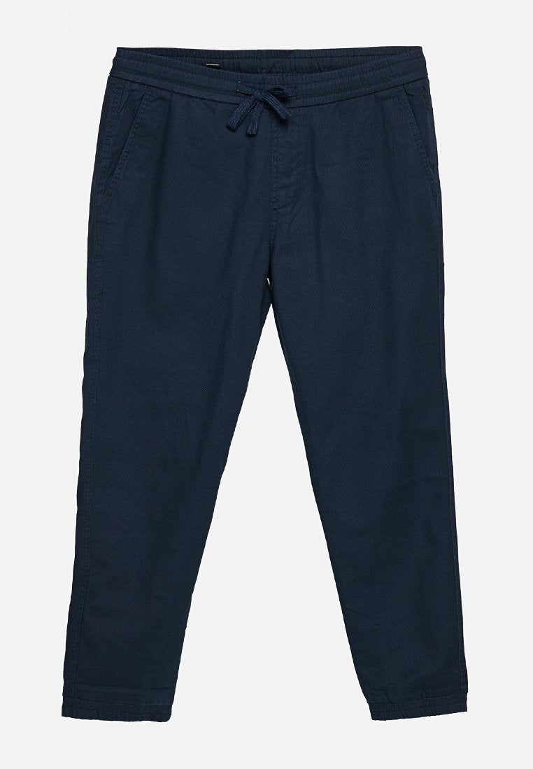 Marineblaue lässige Hosen mit elastischem Bund und Kordelzug, Fronttaschen, geraden Beinen und Bündchen an den Knöcheln.