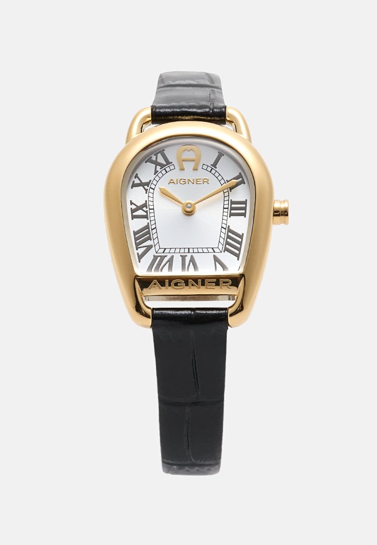 Goldene Aigner Armbanduhr mit schwarzem Lederarmband, weißem Zifferblatt, römischen Zahlen und goldenen Zeigern, die 10:11 anzeigen.