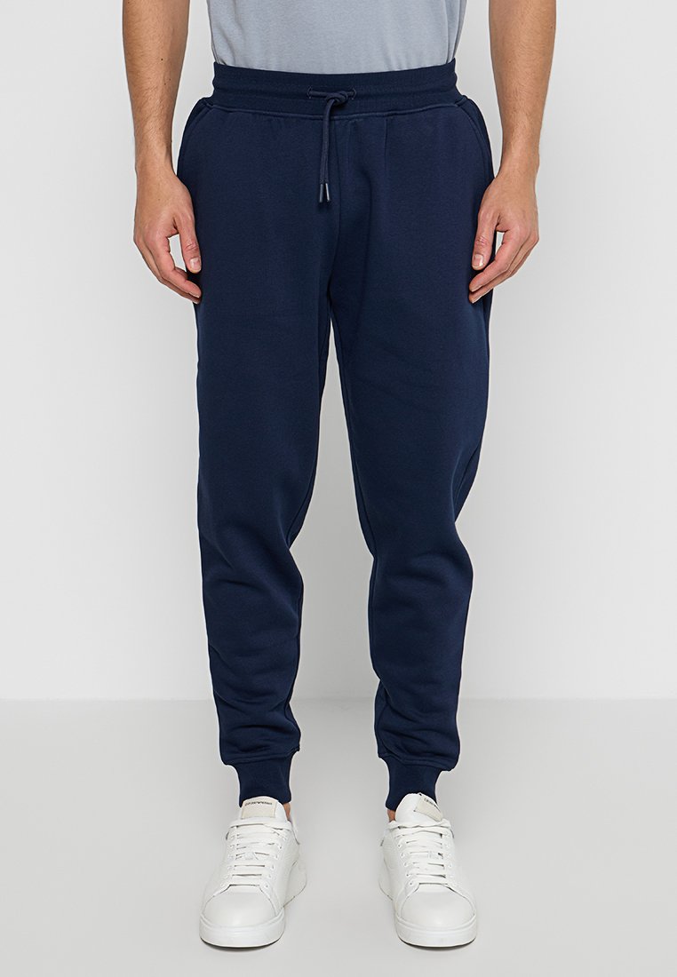 Marineblaue Jogginghose aus weichem Stoff, mit einem elastischen Bund und Kordelzug, engen Bündchen und Seitentaschen.