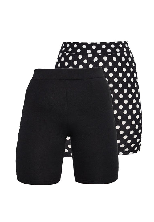 Zwei Paare Damen-Hochbund-Shorts, eines einfarbig schwarz und eines schwarz mit großen weißen Punkten, auf weißem Hintergrund präsentiert.