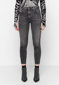 Schmale schwarze Jeans mit dezentem Used-Look und fünf Taschen, kombiniert mit schwarzen Absatzstiefeln, die ein geripptes Knöcheldesign aufweisen.