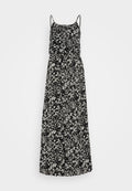 Maxikleid mit schwarz-weißen abstrakten Blattmustern, Spaghettiträgern, einem taillierten Oberteil und einem fließenden Rock. Hergestellt aus leichtem Stoff.