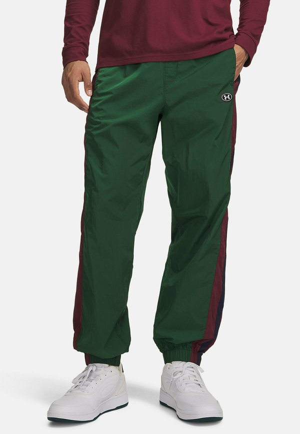 Under Armour ICON WOVEN TRACK - Tracksuit bottoms - forest green