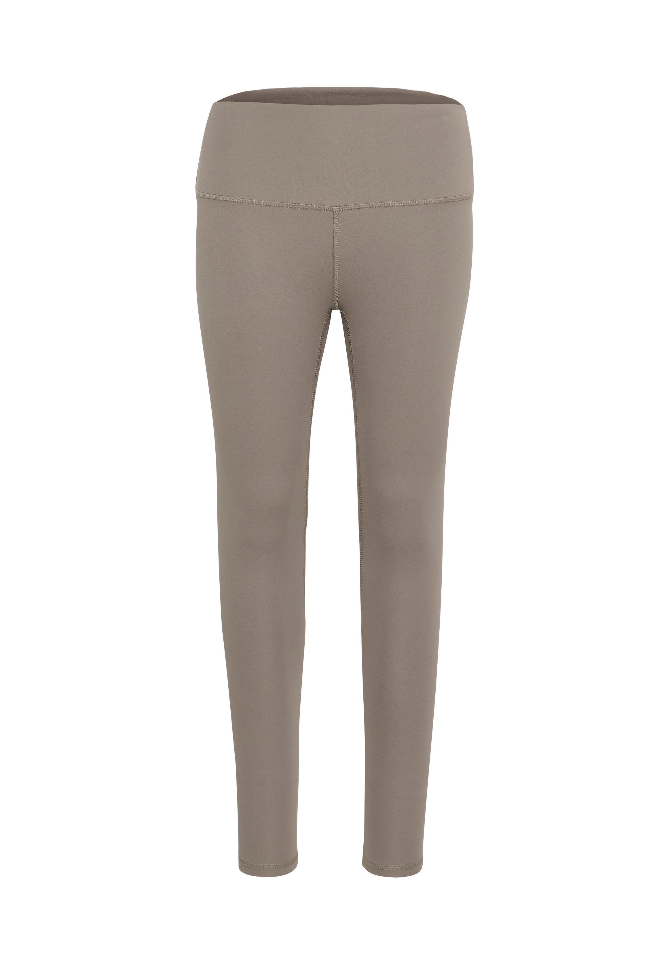 Beige Leggings aus dehnbarem Stoff, mit einem breiten, flachen Bund und einer glatten Textur, die für Komfort und Bewegungsfreiheit entwickelt wurden.
