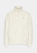 Cremfarbener Reißverschlussjacke mit hohem Kragen, elastischen Bündchen und Saum, mit einem kleinen Logo auf der linken Brust. Glatte Stoffoberfläche.