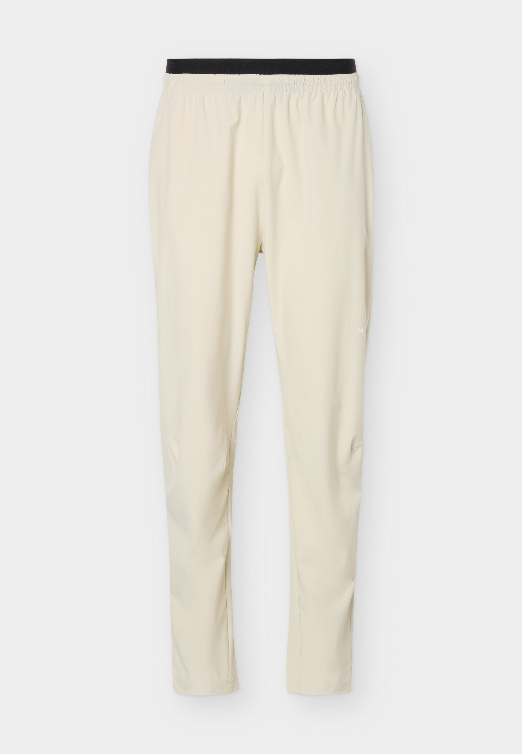 Beige Slim-Fit-Hose mit schwarzem elastischem Bund, aus leichtem, glattem Stoff, geeignet für Freizeit- oder Sportbekleidung.