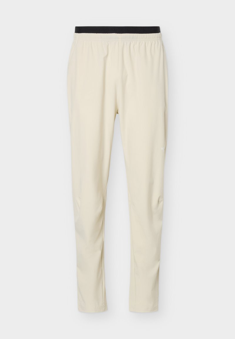 Beige Slim-Fit-Hose mit schwarzem elastischem Bund, aus leichtem, glattem Stoff, geeignet für Freizeit- oder Sportbekleidung.