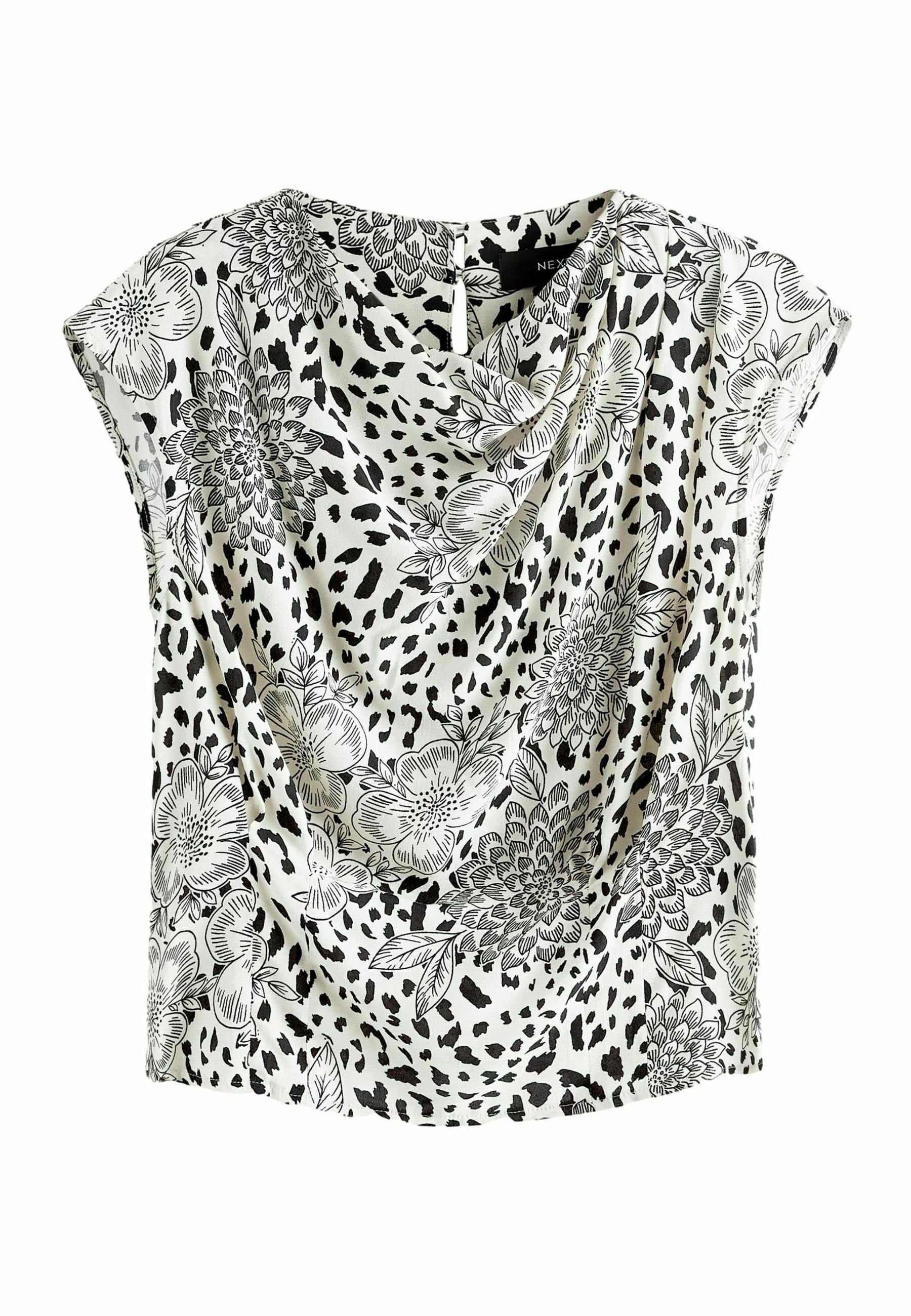 Bluse mit floralem Muster, Drapierung vorne, kurzen Ärmeln und einer Mischung aus Schwarz und Weiß. Hergestellt aus leichtem Stoff mit glatter Textur.