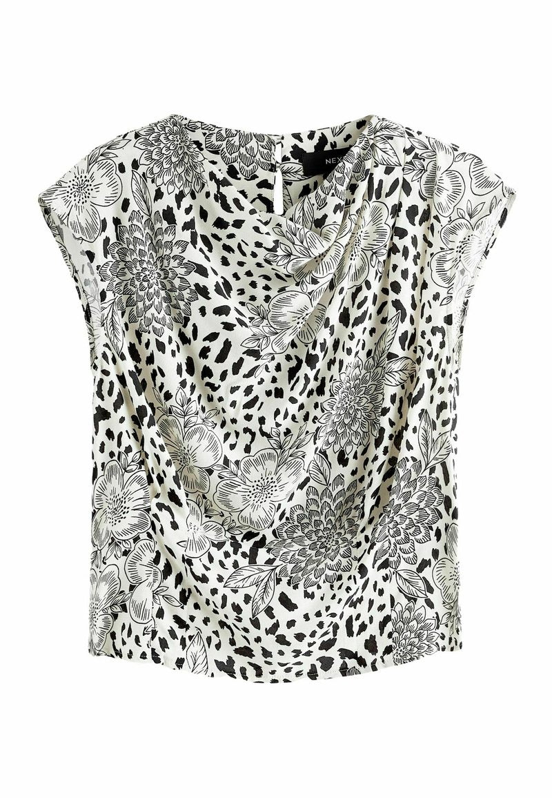 Bluse mit floralem Muster, Drapierung vorne, kurzen Ärmeln und einer Mischung aus Schwarz und Weiß. Hergestellt aus leichtem Stoff mit glatter Textur.