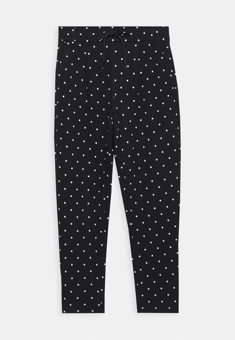 Schwarze Hose mit elastischem Bund, verziert mit weißen Tupfen, enganliegend und glatt. Keine sichtbaren Taschen.