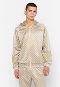 Beige gesteppte Zip-Jacke mit Kapuze, versehen mit orangen Akzenten und gestreiften Marken, kombiniert mit passenden Hosen aus glattem Stoff.