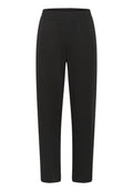 Schwarze Hosen aus weichem, elastischem Stoff. Mit einem elastischen Bund und einem taillierten Bein-Design. Keine Taschen oder sichtbaren Nähte.