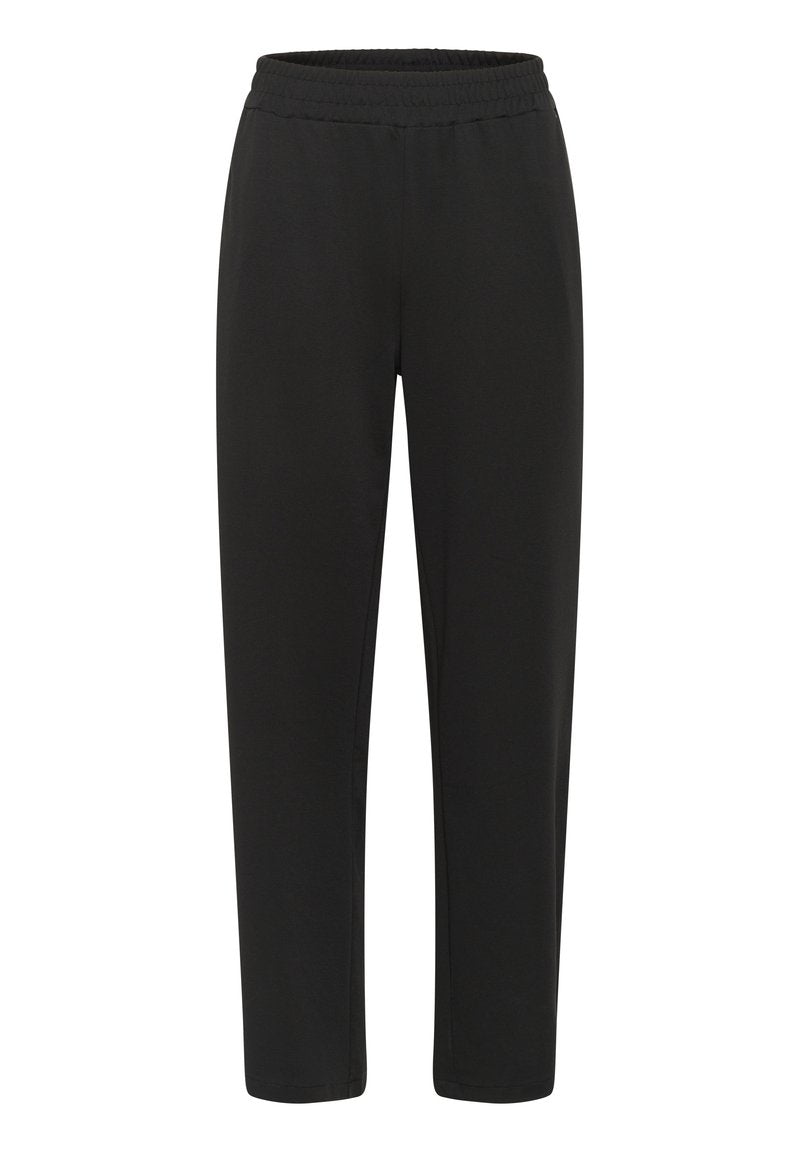 Schwarze Hosen aus weichem, elastischem Stoff. Mit einem elastischen Bund und einem taillierten Bein-Design. Keine Taschen oder sichtbaren Nähte.