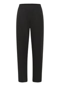 Schwarze Hosen aus weichem, elastischem Stoff. Mit einem elastischen Bund und einem taillierten Bein-Design. Keine Taschen oder sichtbaren Nähte.