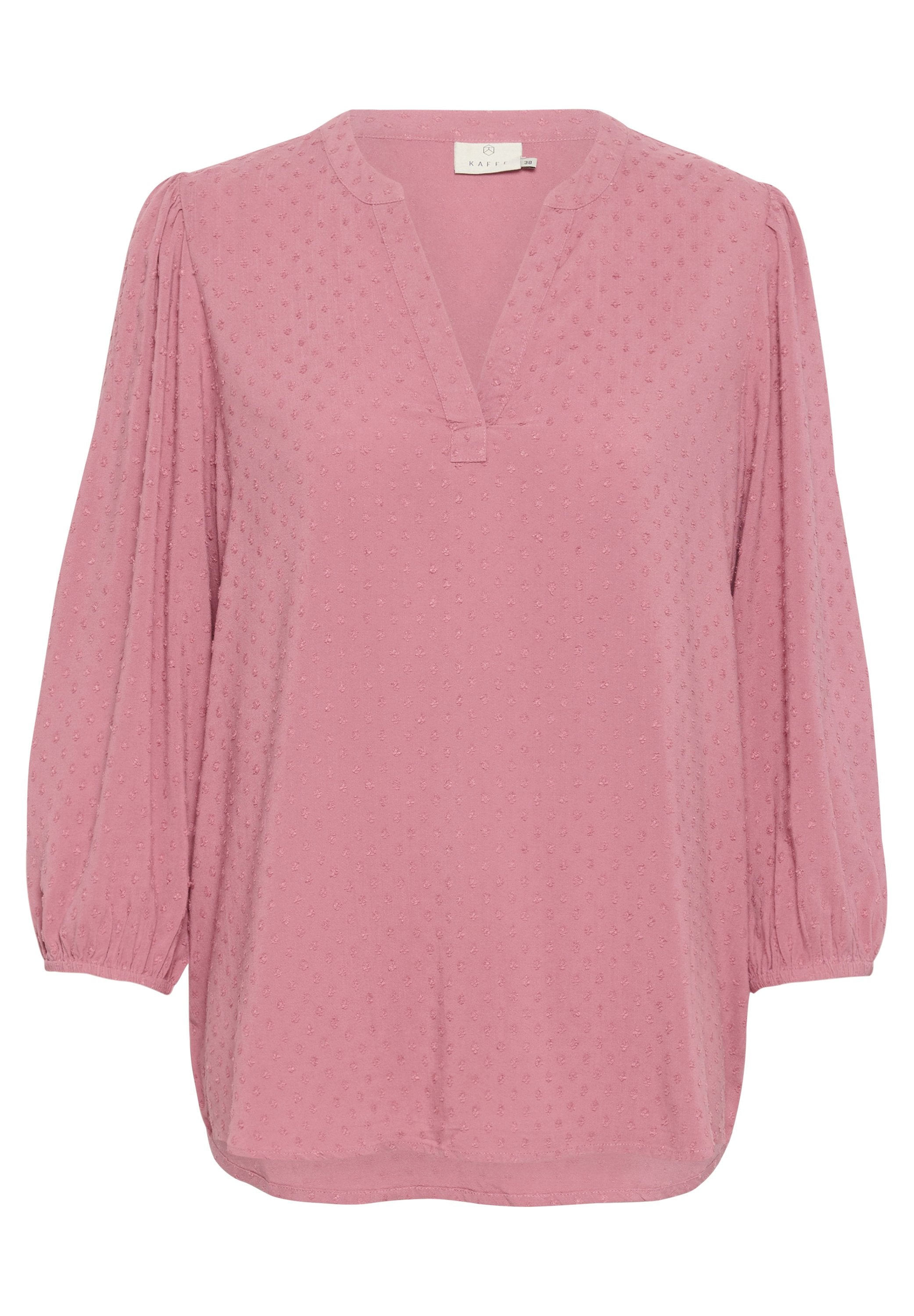 Helle rosa Bluse mit V-Ausschnitt, langen Puffärmeln und strukturiertem gepunktetem Stoff. Abgerundeter Saum und dezente Nähedetails.