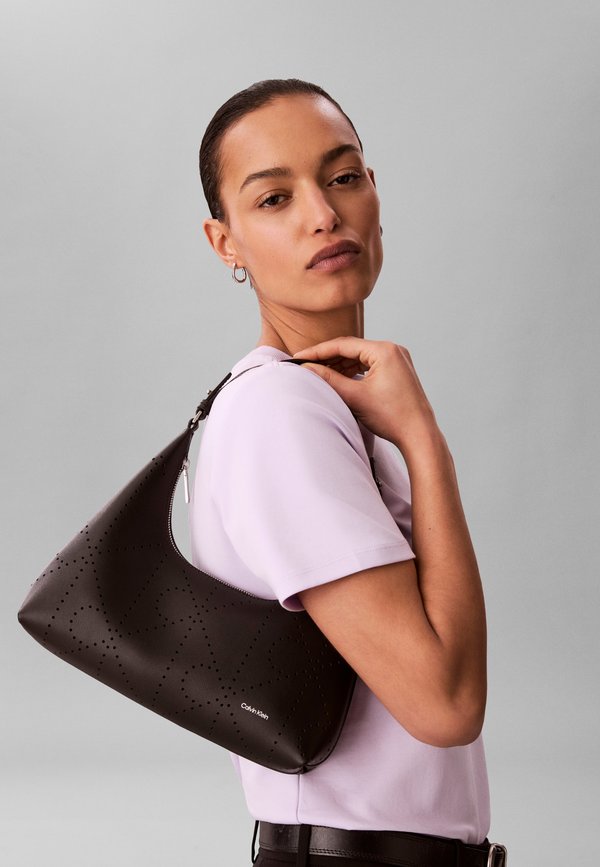 Calvin Klein EMBLEM PERFOR BAG - Handbag - black