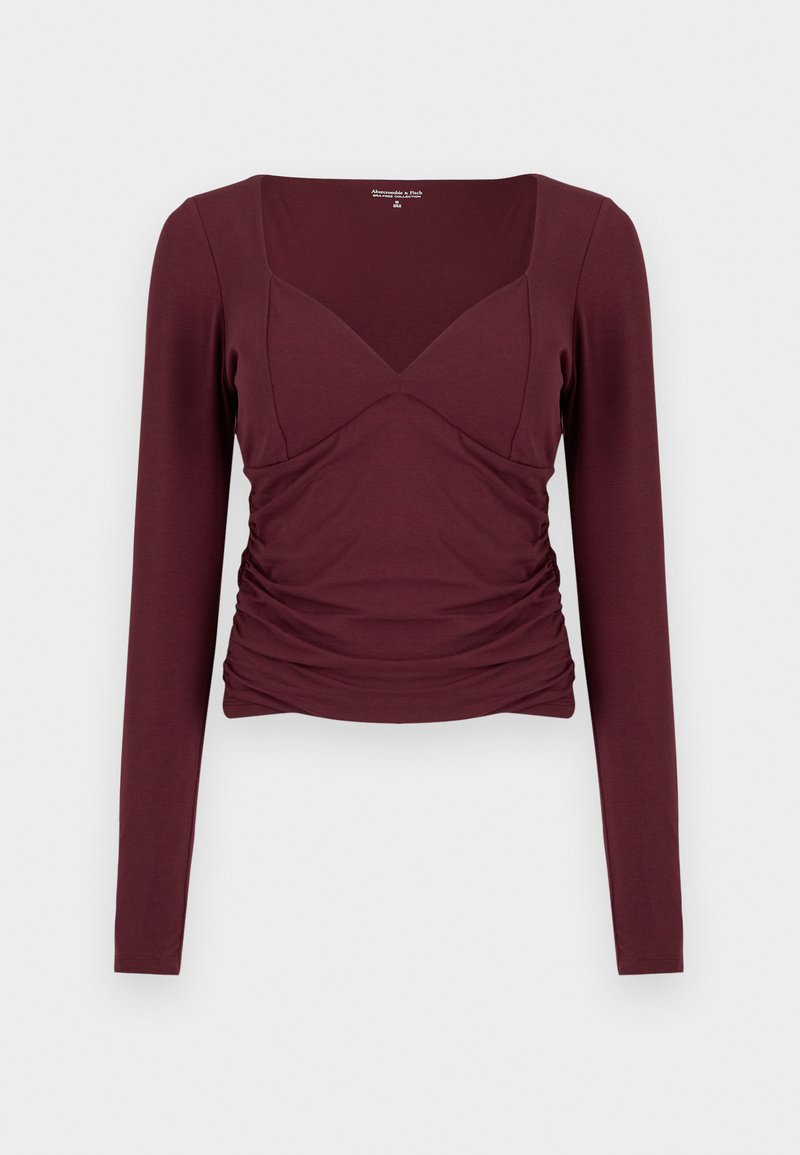 Bordeauxrotes Langarmshirt mit quadratischem Ausschnitt, gerafften Seiten und figurbetontem Design aus weichem, dehnbarem Stoff.
