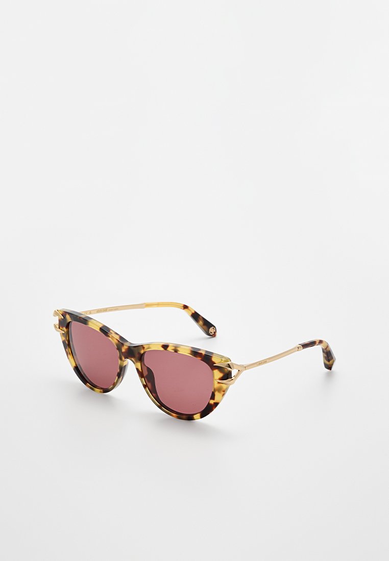 Schildpatt Katzenaugen-Sonnenbrillen mit rosa Gläsern und dünnen goldenen Metallarmen auf einer weißen Oberfläche.