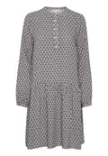 Langärmliges Kleid in Beige mit einem navyfarbenen Fächer-Muster. Es hat einen runden Halsausschnitt, eine Knopfverschluss und ein mehrlagiges Rockdesign.