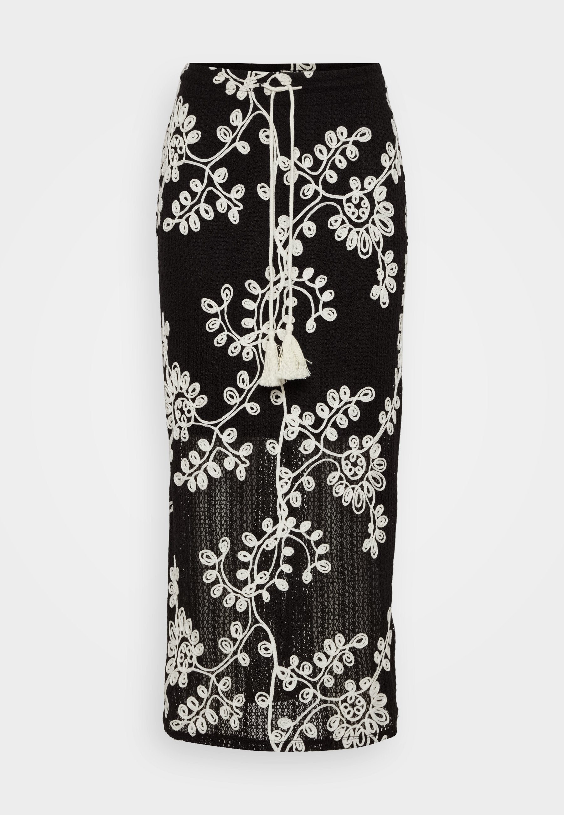 Schwarzer Strickrock mit aufwendiger weißer Blumenstickerei, verstellbarem Zugband mit Quaste und figurbetontem Schnitt.